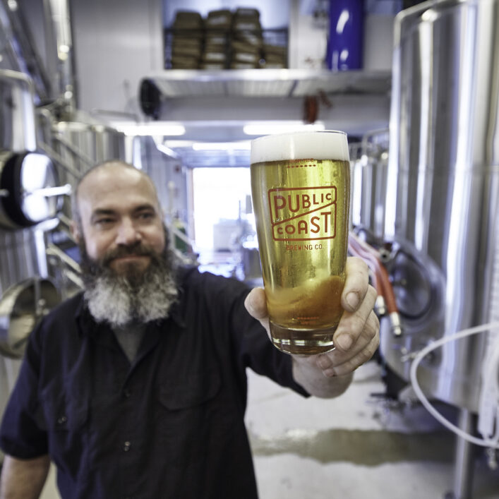Public Coast Brewmaster Holding Beer